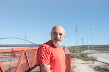 Senior sportsman resting after running training