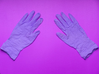 Pair of latex medical gloves on purple background. Protection concept. COVID-19. Epidemic background.  Quarantine background. Medical gloves for protection. Dangerous virus. gloves for test.copy space