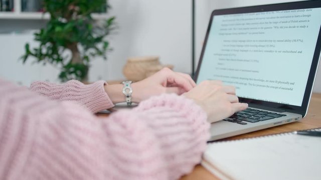 Close up of Female Hands Editting Text on Laptop Keyboard. Woman Works in Home Office. Online education or Freelance concept. Self-isolation concept at Coronavirus Pandemic. 4K Background Orbit Shot