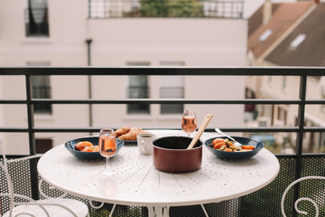 Yummy and healthy breakfast with eggs, tomatoes, avocado, wine, coffee and croissants on the terrace. French breakfast