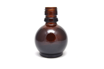 Brown glass bottle on a white background close up
