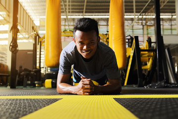 Male athletes are planking to build the abdominal muscles.