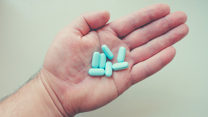 Vitamins, medicine on the palm of your hand. Different positions and colors.