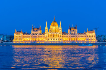 sunset over the river in the city of Budapest with the Parliament