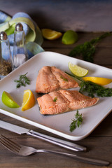 Poached salmon fillets. Boiled salmon on white plate. Healthy diet fish dish