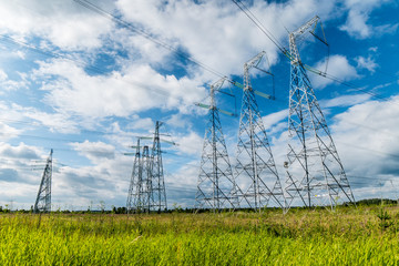 The transmission lines in green field in summer 