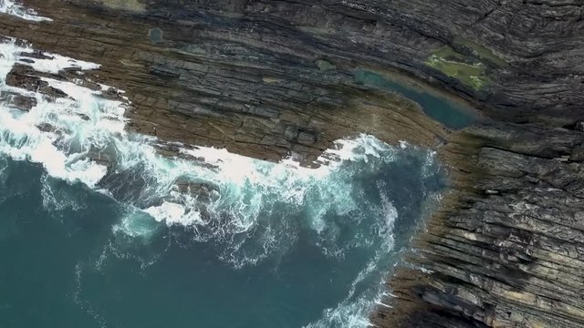 Aerial Irish coastline drop high to low