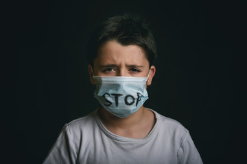Stop,crying child wearing medical mask for coronavirus