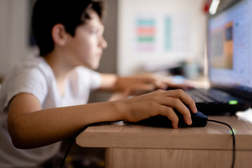 A child using a computer in his bedroom