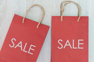 SALE sign on bag: it's time for a shopping spree ,Colorful autumn leaves in colorful paper shopping bags. Sale and shopping concept,Red shopping bag 