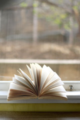 Open book on a table. Selective focus.