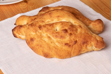homemade bread on a white bland napkin closeup. Flour products of Georgian cuisine.

