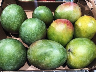 Fresh green mangoes on the market 