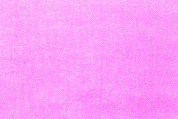 The texture of a luxurious pink satin fabric or silk close-up. Can be used for wedding, romantic background or for Valentine's day.