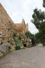 Fototapeta na wymiar Road under the wall of old medieval Sagunto fortress, Valencia, Spain
