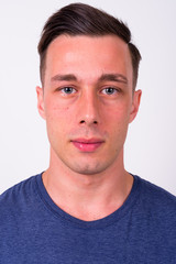 Fototapeta premium Face of young handsome man looking at camera
