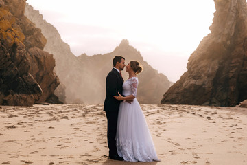 profile of newlyweds embraced each other against the backdrop of