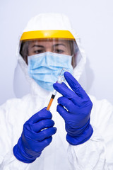 nurse with coronavirus protection equipment loads medication with a syringe selected focus