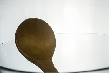 wooden spoon orbiting a glass bowl