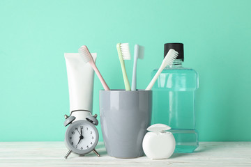 Tools for dental care on mint background, close up