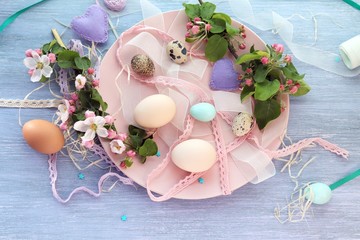 Eggs, Easter decoration, apple tree flowers on a wooden surface on a window background