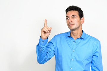 Portrait of mature handsome thinking and pointing up