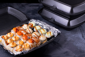 Set of sushi rolls in disposable containers. Food delivery service concept