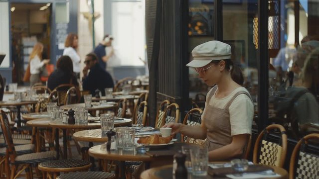 Young girl drinking coffee in a cafe in the morning