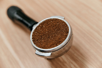 Freshly ground coffee in the holder for making a portion of coffee in the coffee machine