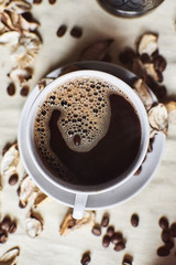 A Cup of espresso coffee drink on a white saucer top view