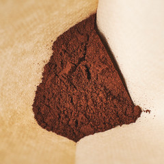 A handful of freshly ground coffee in the filter for making in the coffee machine