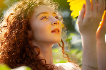 Fototapeta premium Redhair girl in sunflowers