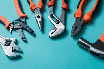 group bunch of tools with orange handles on a blue background close