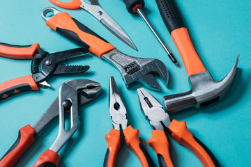 group bunch of tools with orange handles on a blue background close