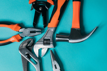 group bunch of tools with orange handles on a blue background close