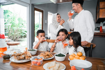 thristy family drinking sweet drink for breaking the fast on ramadan month