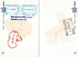Stamps of Vietnam, Qatar and Montenegro in a French passport. Personal data removed