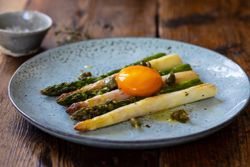 Roasted white and green aspatagus with capers and mustard dressing and cured egg yolk