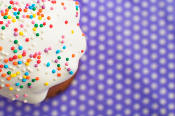 One Easter cake on a purple background close-up. Kulich is shifted to one side of the frame.