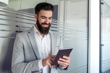 Young man using his tablet in the office