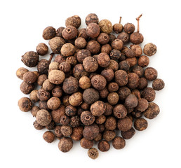 A pile of dried allspice on a white background. The view from top