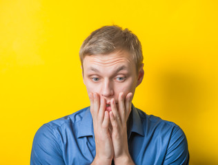 Portrait of young blond man looking contemplative up in the air. Isolated on white background.