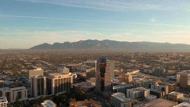 Beautiful Sunrise Over The Downtown Skyline In Tucson With A Mountains And Blue Sky On The Background In Tucson, Arizona, USA. - aerial shot