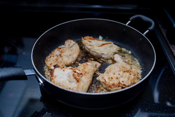 Frying or browning chicken breast stove top in butter and garlic