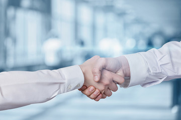 Handshake of doctors on a blurred background.