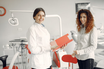 Obraz premium Woman in the dentist's office. Doctor in a uniform.