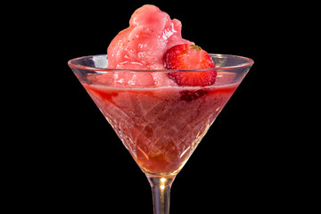A delicious frozen strawberry daiquiri on black background. Close up