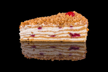 Piece of traditional french cake with custard, isolated on black background.