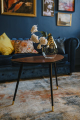 Modern interior design of a pressed table with a vase for artificial flowers