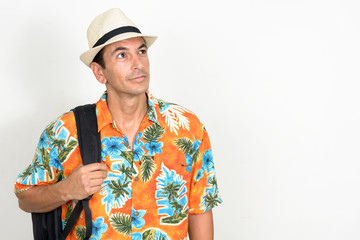 Portrait of mature handsome tourist man with backpack thinking